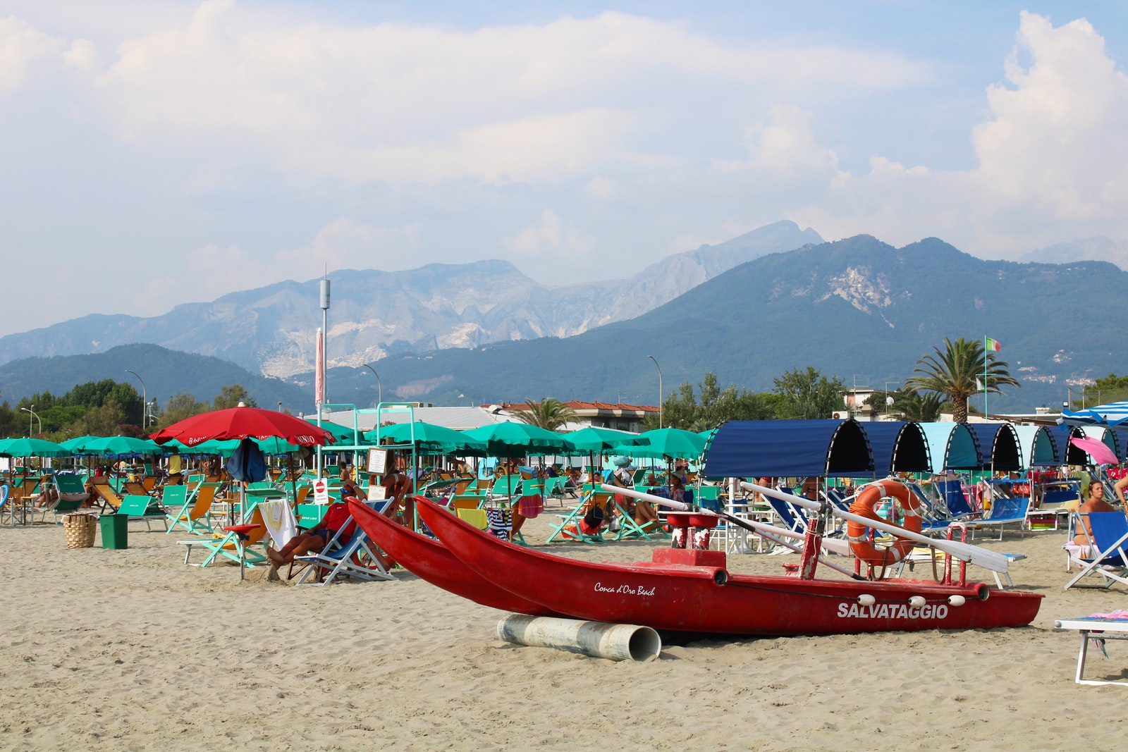 red boat on beach during daytime