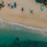 a group of boats sitting on top of a sandy beach